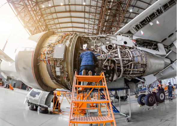 Technician fixes a plane engine turbine